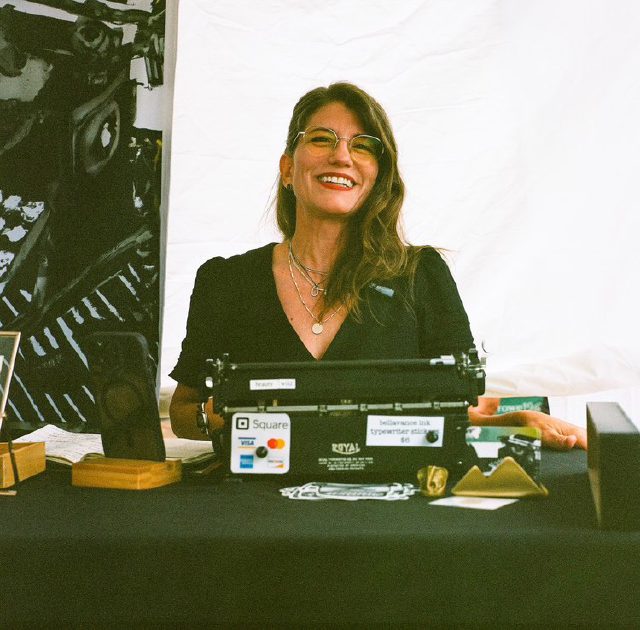 Laura at the Charlottesville Poem Store, writing poems on a Royal typewriter
